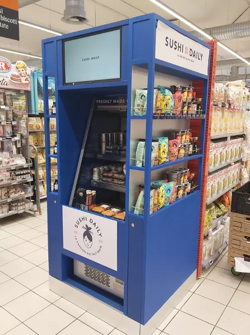 Sushi Daily concession fitted in a supermarket aisle, screen at the top of the unit