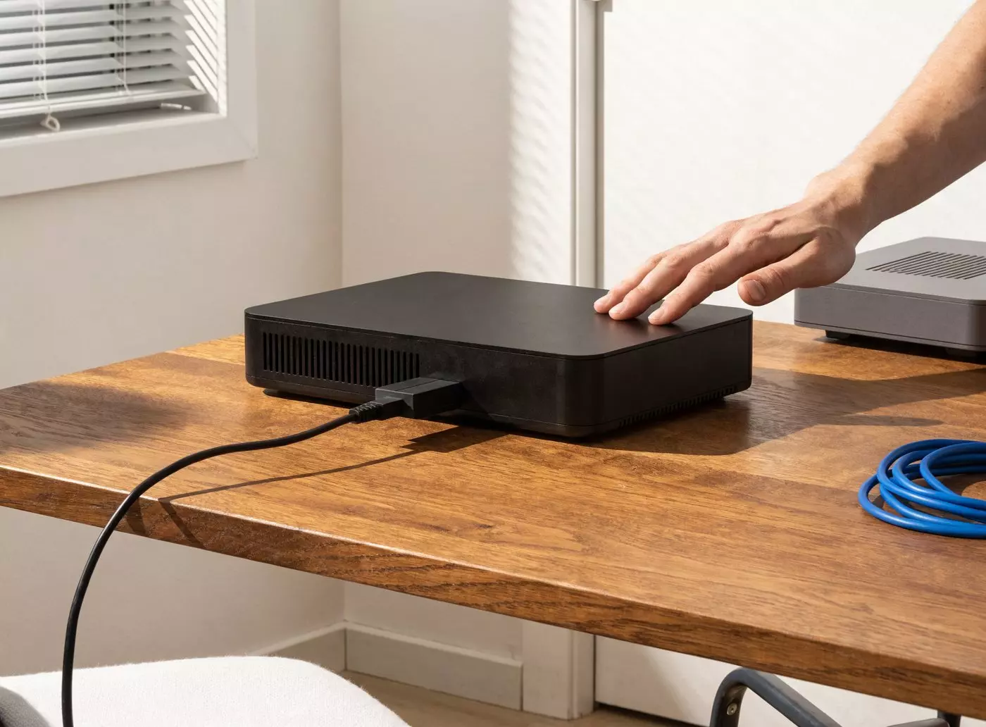 IPTV encoder on a desk with an HDMI cable plugged in, TV set-top box and network cable alongside