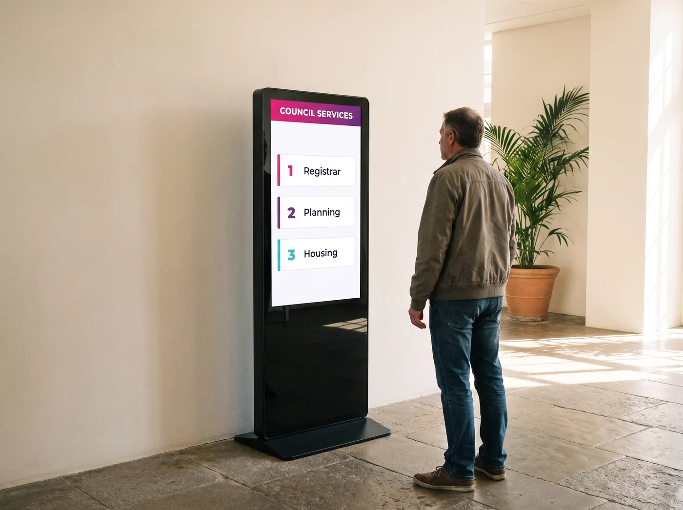 Portrait touch totem in a council building lobby listing the service desks, being read by a resident