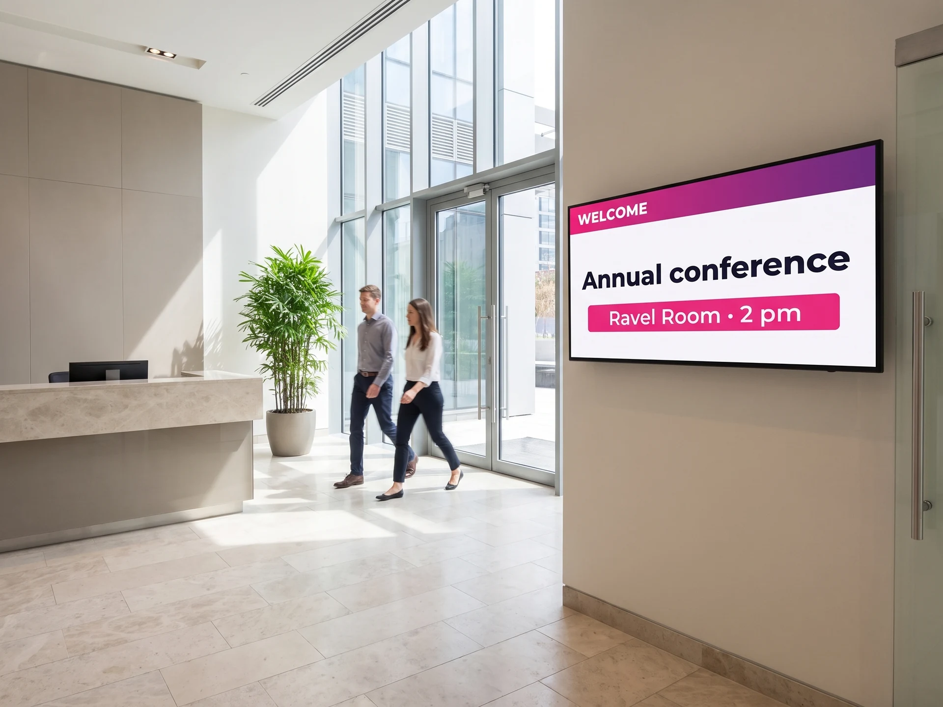 Wall-mounted screen in an office building lobby announcing a conference