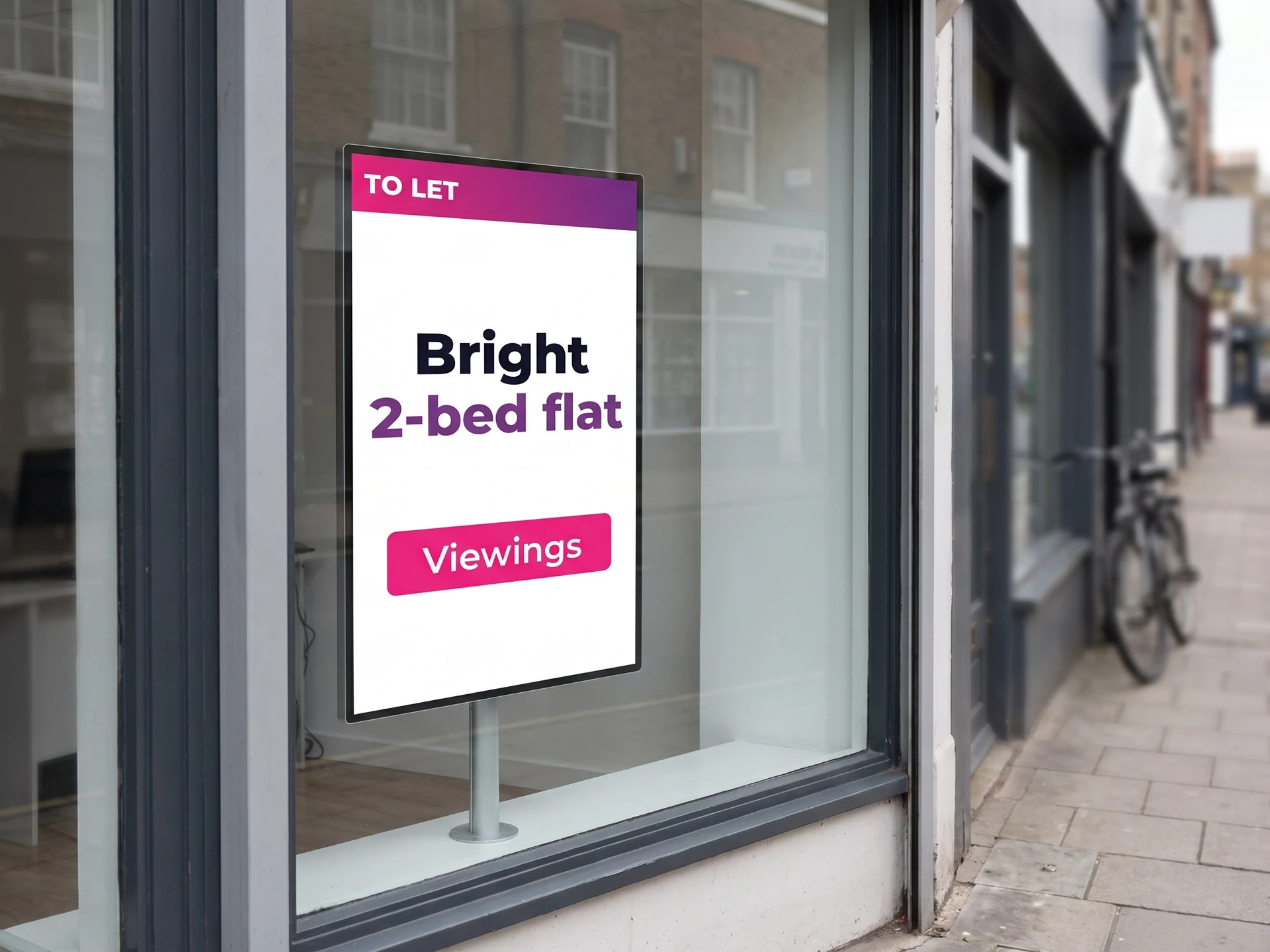 Portrait screen behind an estate agent’s window showing a property to let
