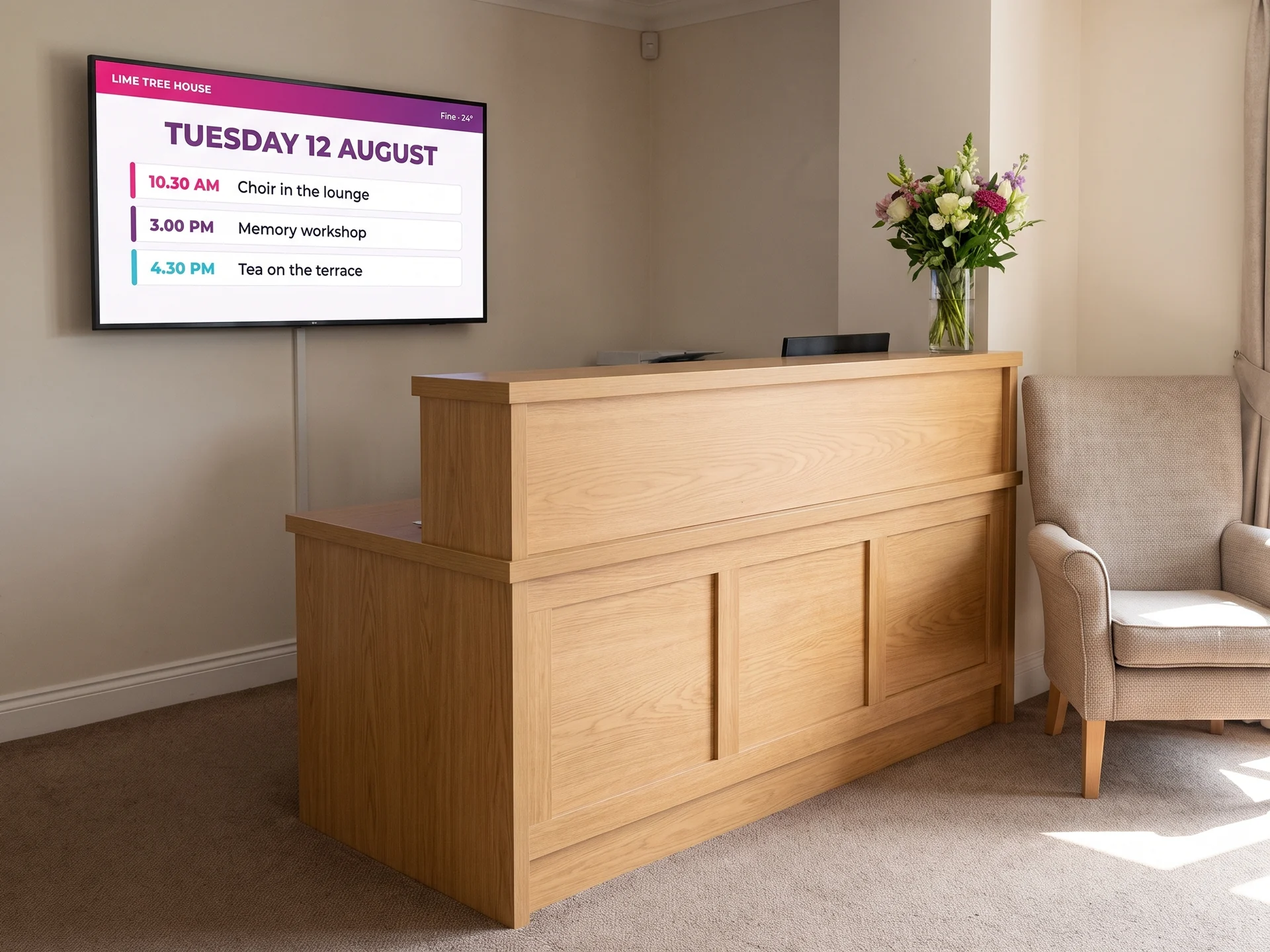 Digital signage screen beside the reception desk of a care home, showing the day’s date and activities