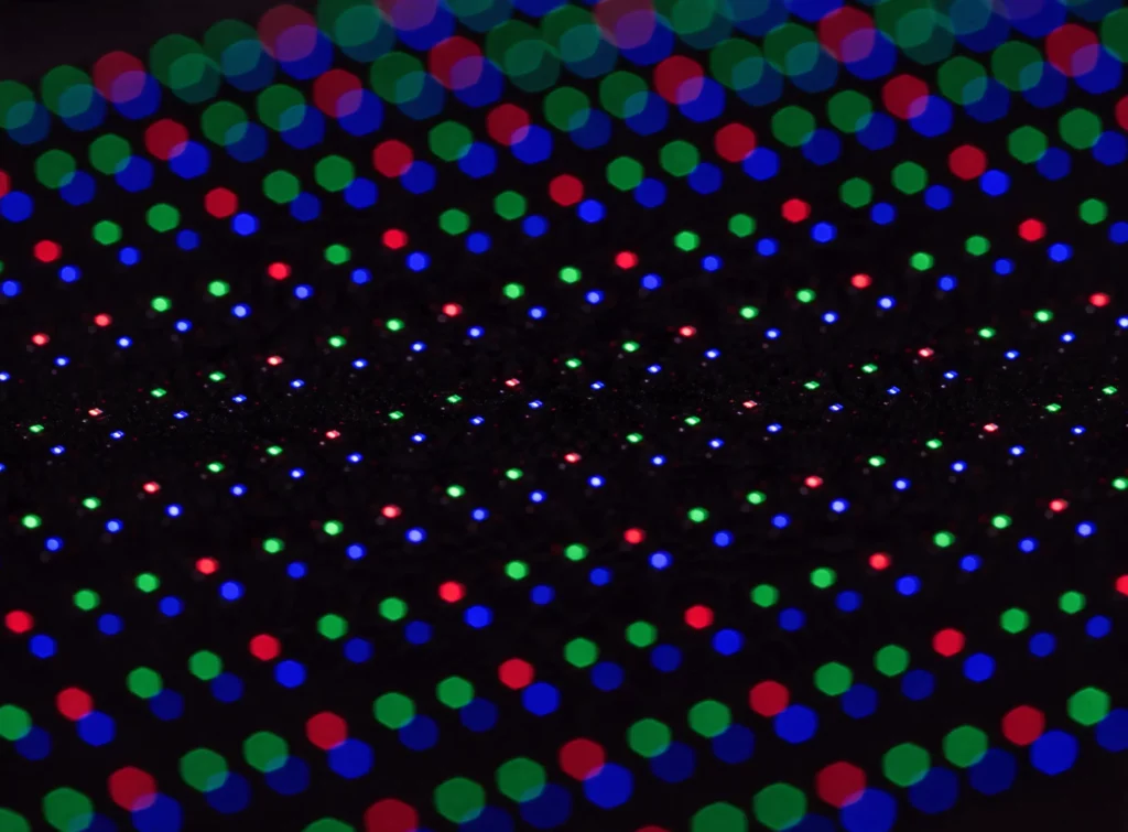 Close-up of the diodes on an LED screen module, the pitch between two diodes visible at short range