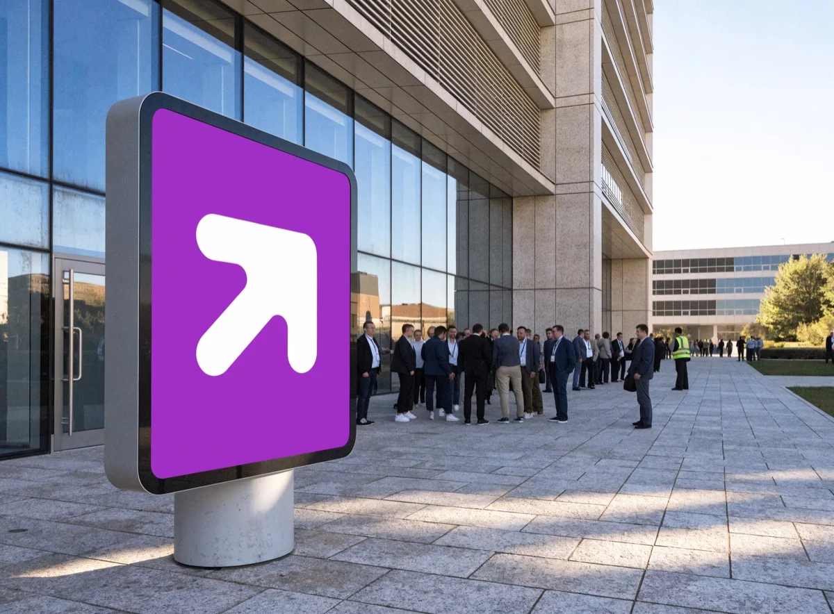 Outdoor totem pointing to the assembly point during an evacuation drill outside an office building