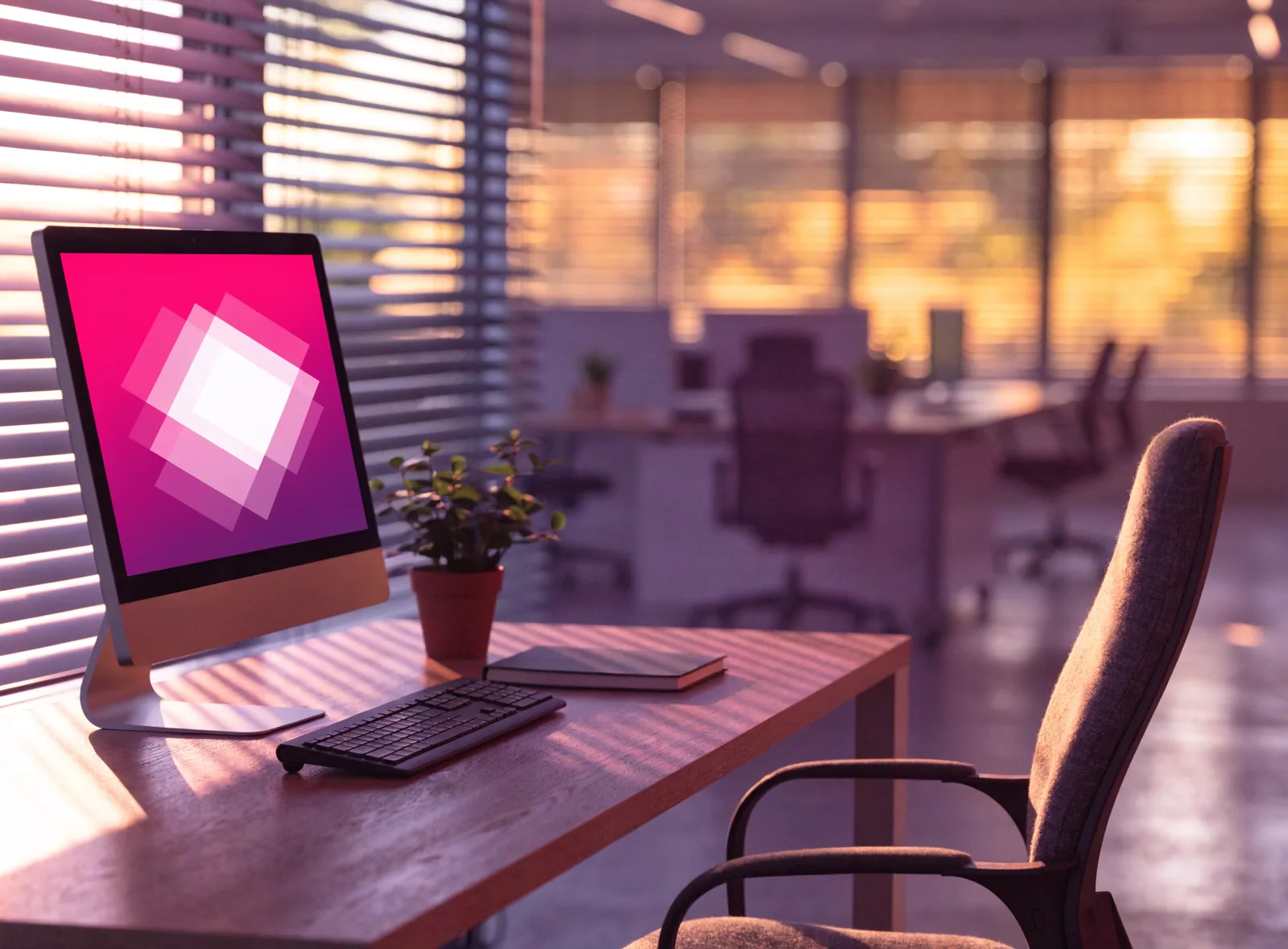 Empty workstation whose monitor displays an internal communication in screensaver mode