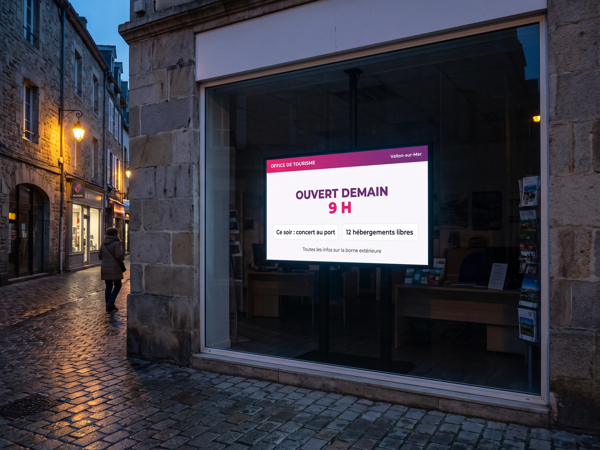 Écran d'affichage dynamique en vitrine d'office de tourisme, la nuit