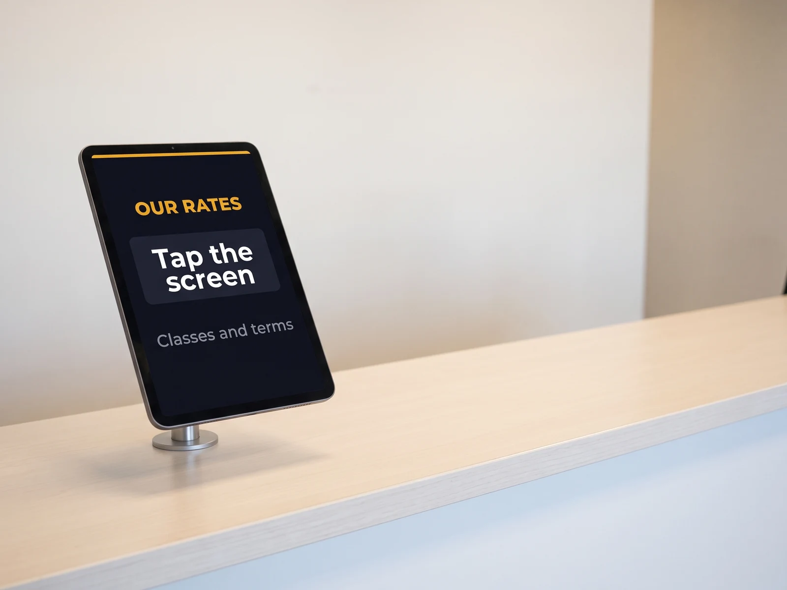 Portrait touch tablet on the counter of a car hire branch, inviting the customer to look through the rates