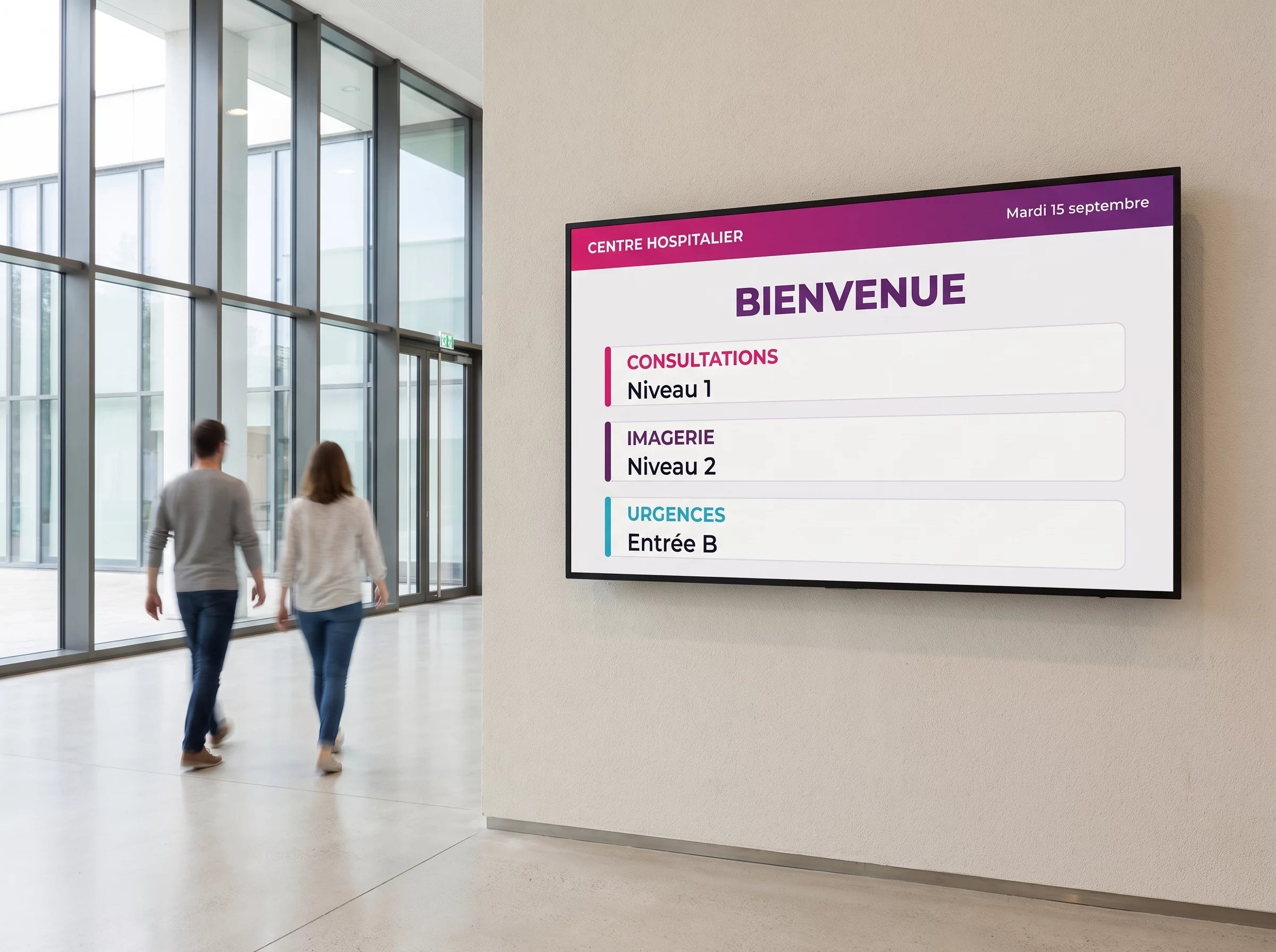 Écran mural dans le hall d'un hôpital indiquant les niveaux des consultations, de l'imagerie et l'entrée des urgences