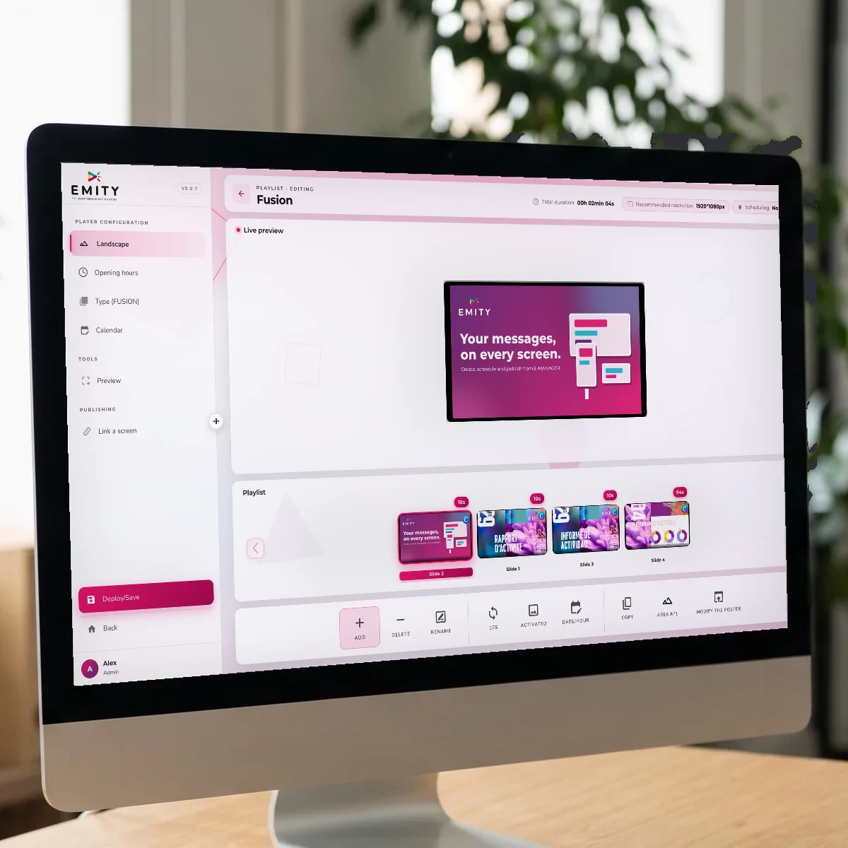 E-MANAGER playlist open on an iMac, with the live preview of the poster