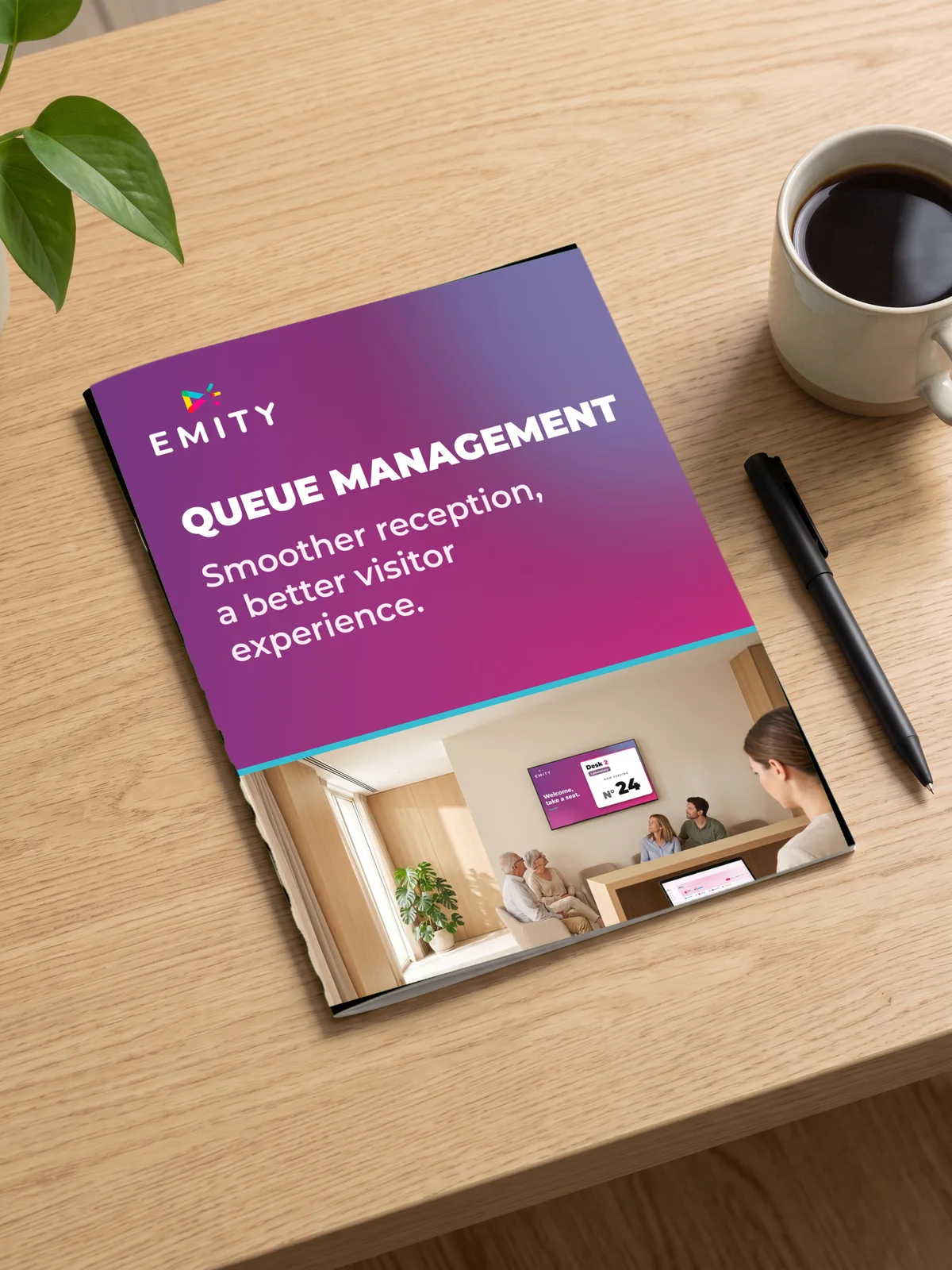 EMITY QUEUE MANAGEMENT brochure lying on a wooden desk, cover reading “Smoother reception, a better visitor experience”