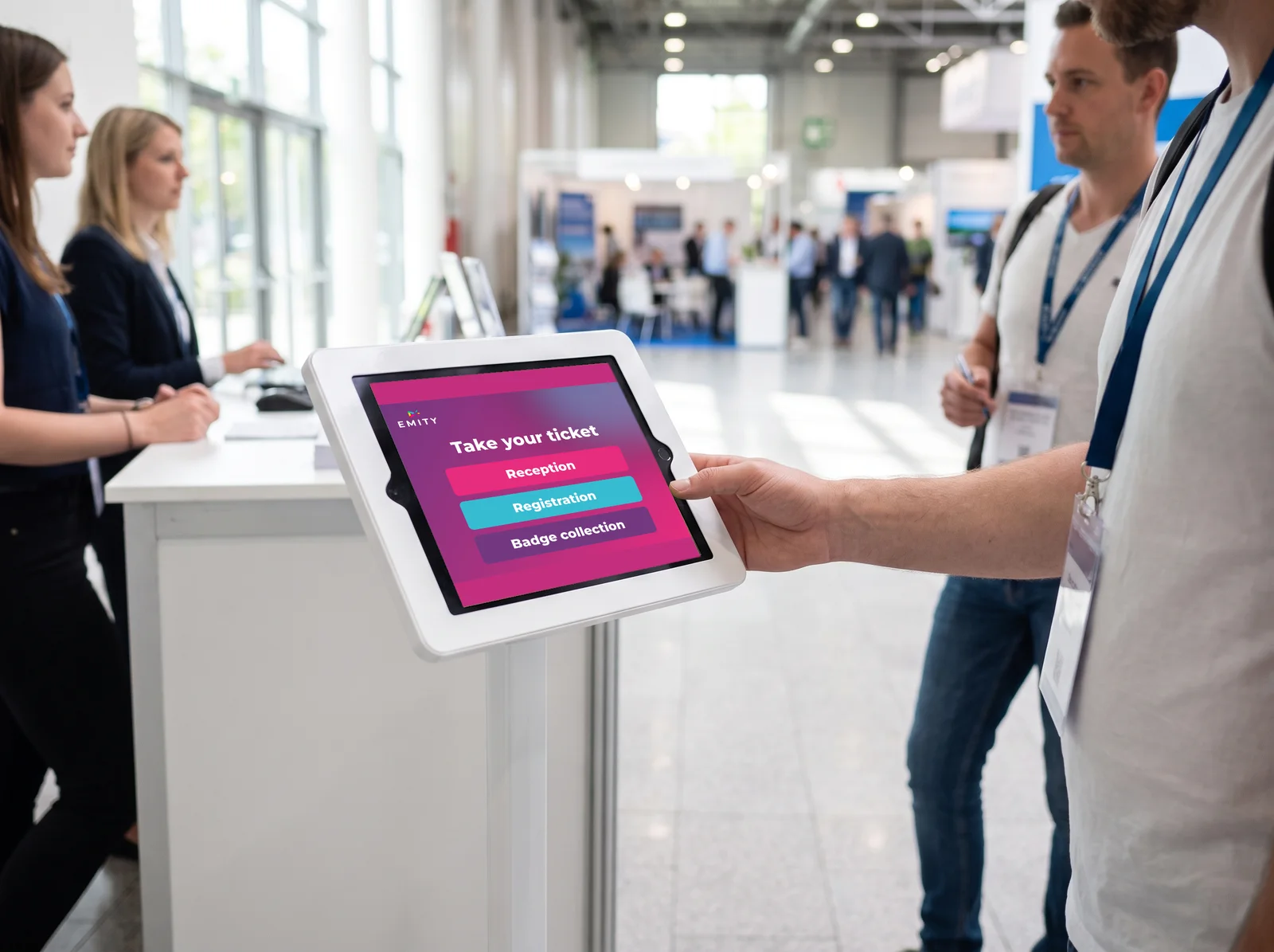Visitor taking a ticket on a reception tablet