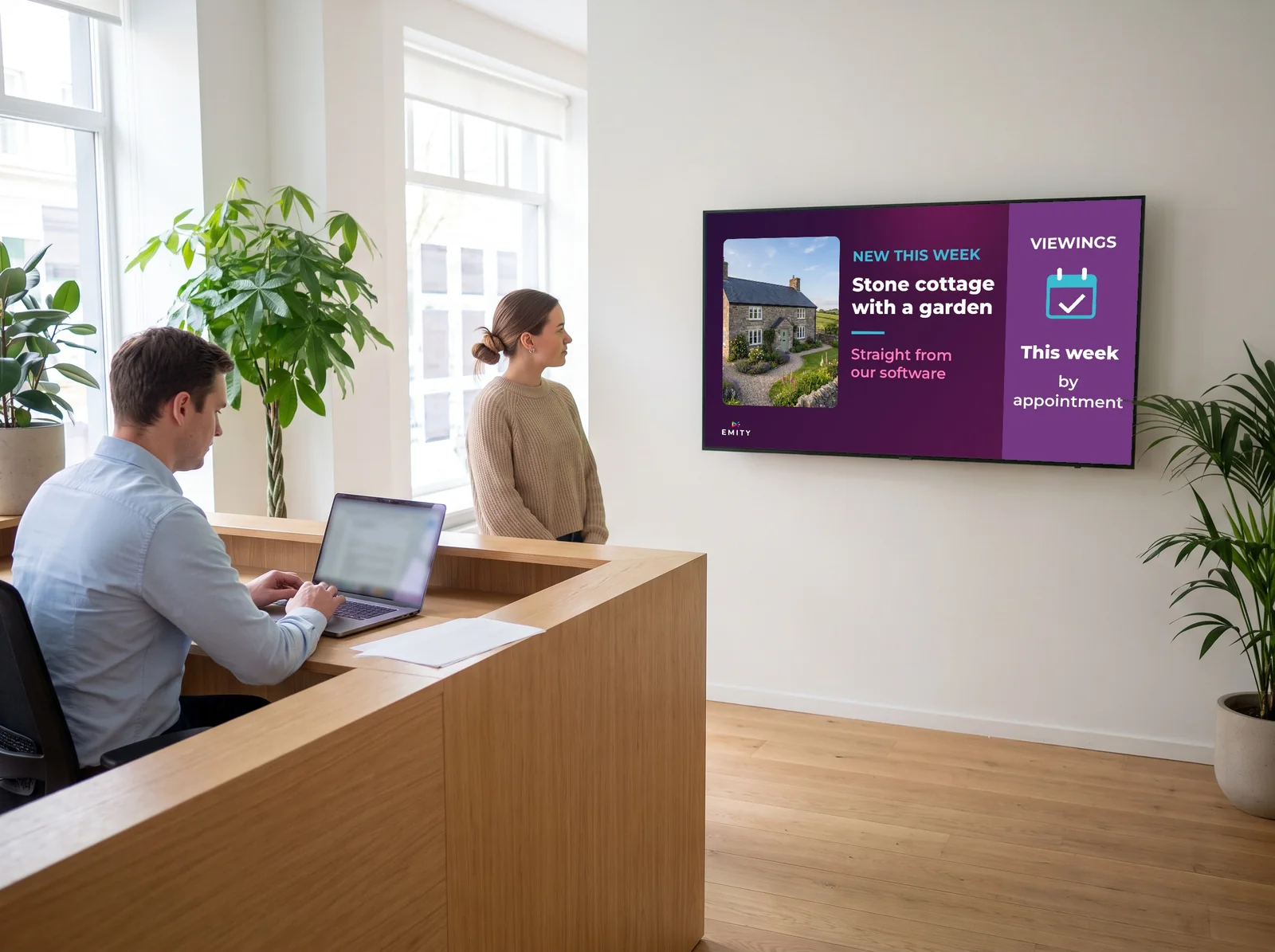 Agency reception: the wall screen shows a stone cottage with a garden, new this week, and viewings by appointment