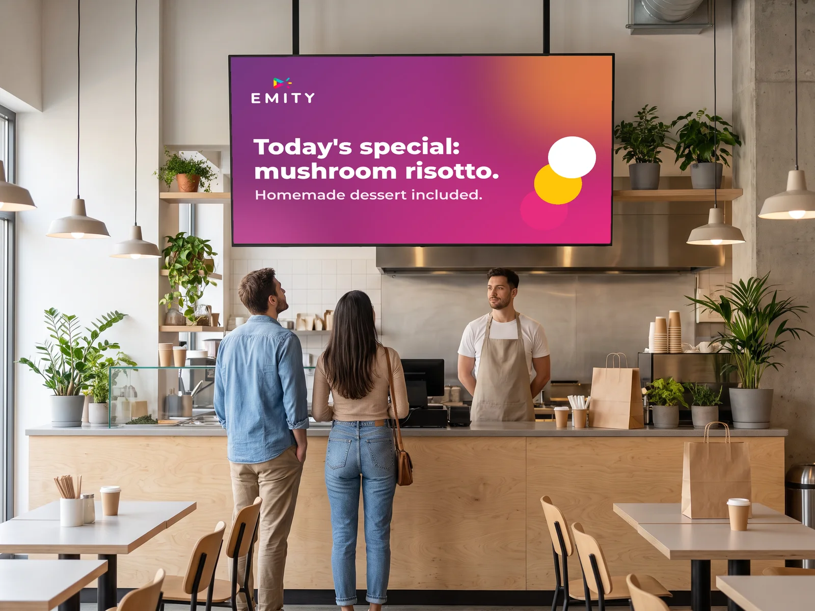 Restaurant counter: two customers read today's special on the screen above the counter