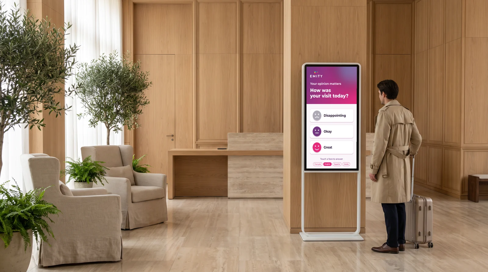 Guest with a suitcase at a satisfaction survey kiosk in a hotel lobby
