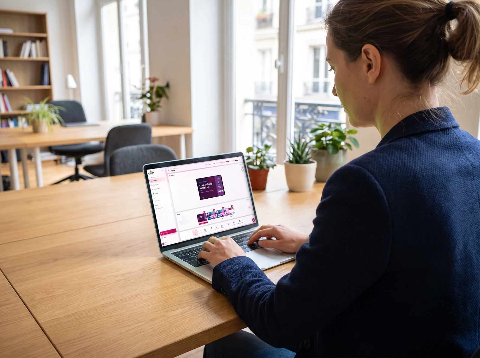 At the network's head office, a manager schedules the clubs' screens in E-MANAGER